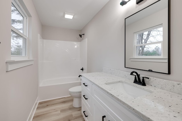 full bathroom with vanity,  shower combination, toilet, and wood-type flooring