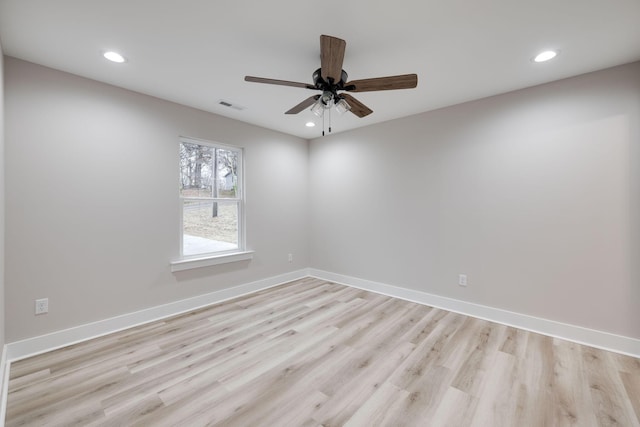 spare room featuring light hardwood / wood-style flooring and ceiling fan