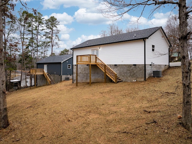 rear view of property featuring central air condition unit and a wooden deck