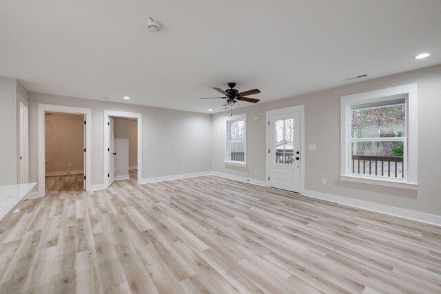 unfurnished living room featuring ceiling fan and light hardwood / wood-style floors