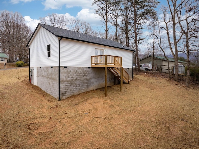 rear view of property with a wooden deck