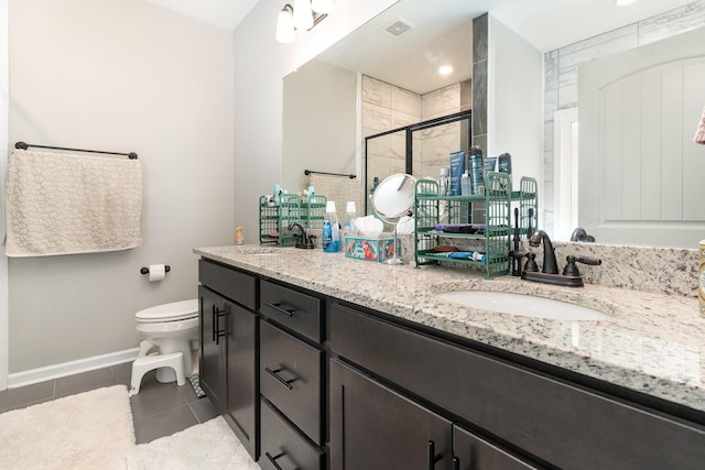 bathroom with toilet, vanity, tile patterned floors, and walk in shower