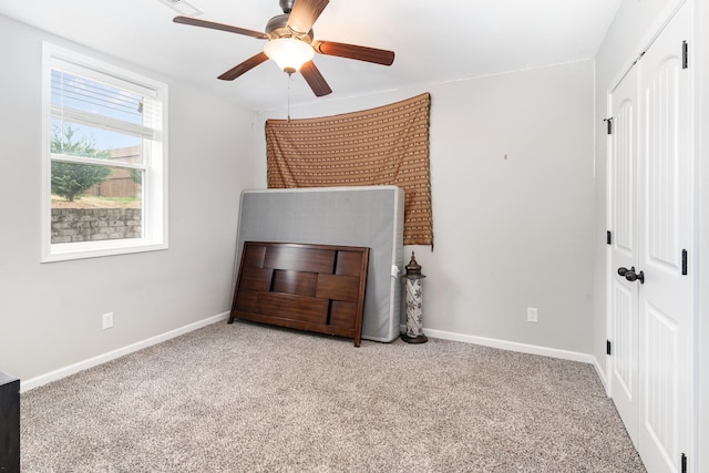 bedroom with light carpet and ceiling fan