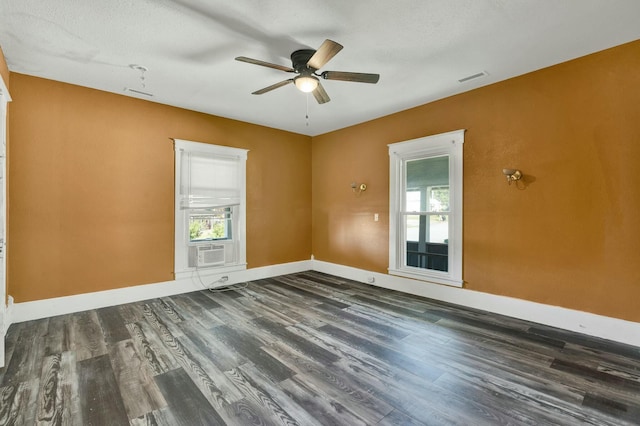 spare room with ceiling fan, cooling unit, dark hardwood / wood-style flooring, and a textured ceiling