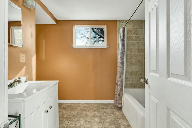 bathroom featuring tile patterned floors, shower / bath combo with shower curtain, and vanity