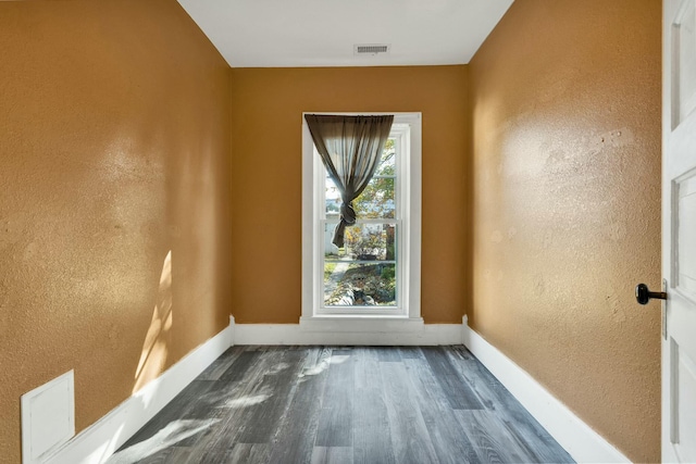 empty room with dark hardwood / wood-style floors