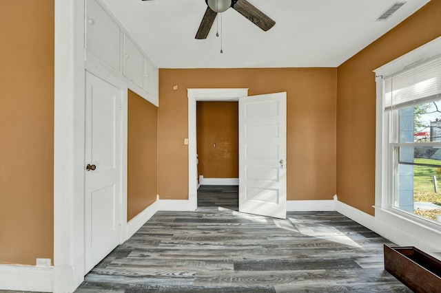 bedroom with multiple windows, ceiling fan, and dark hardwood / wood-style floors