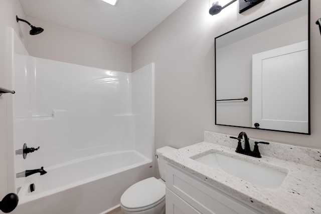 full bathroom featuring washtub / shower combination, vanity, and toilet