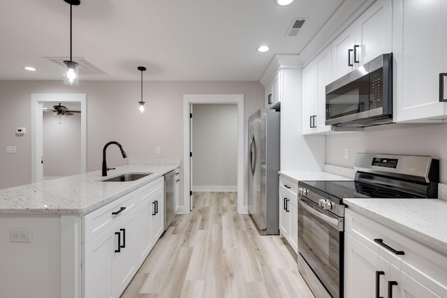 kitchen with stainless steel appliances, white cabinetry, ceiling fan, and sink