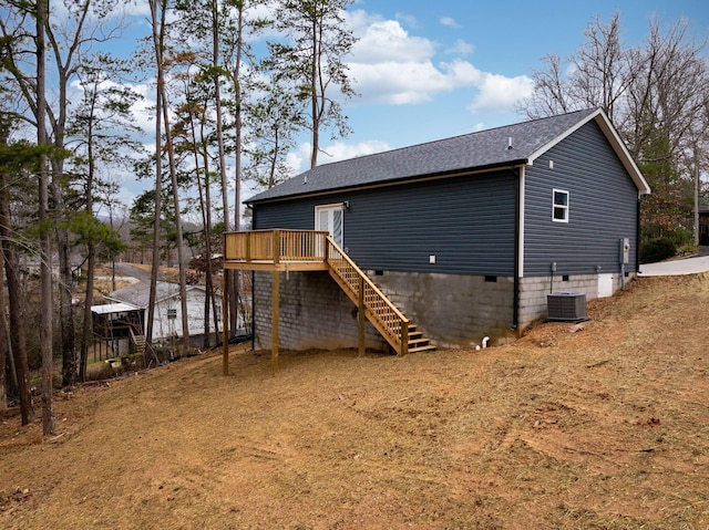 rear view of house featuring central AC and a deck