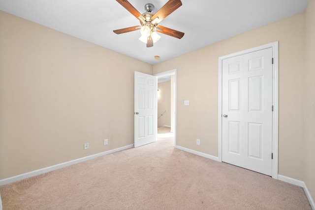 unfurnished bedroom featuring ceiling fan and light carpet