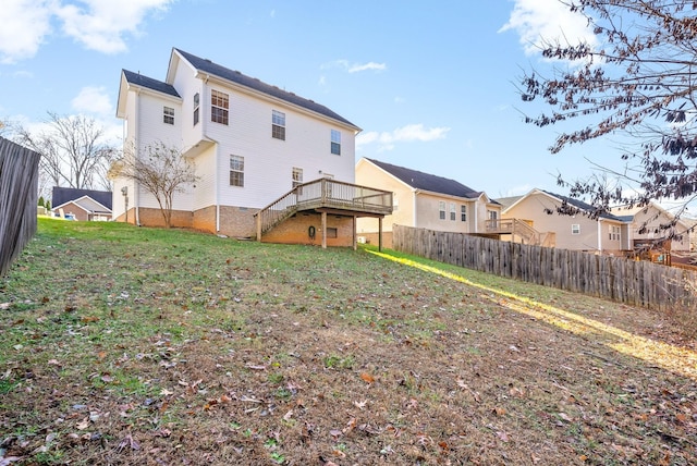 rear view of property with a lawn and a wooden deck