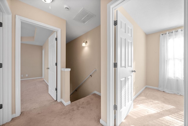 corridor with light carpet and plenty of natural light