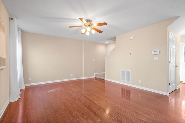 spare room with ceiling fan and dark hardwood / wood-style flooring