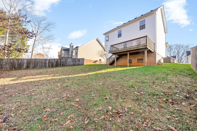 back of property featuring a wooden deck, a yard, and central AC