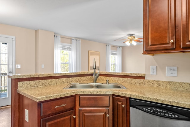 kitchen featuring dishwasher, kitchen peninsula, sink, and a wealth of natural light