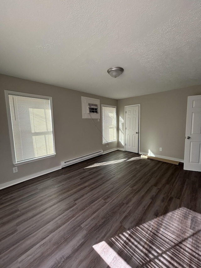 unfurnished living room featuring a baseboard radiator and dark hardwood / wood-style floors