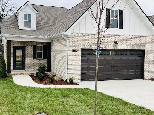 view of front of home with a garage and a front lawn