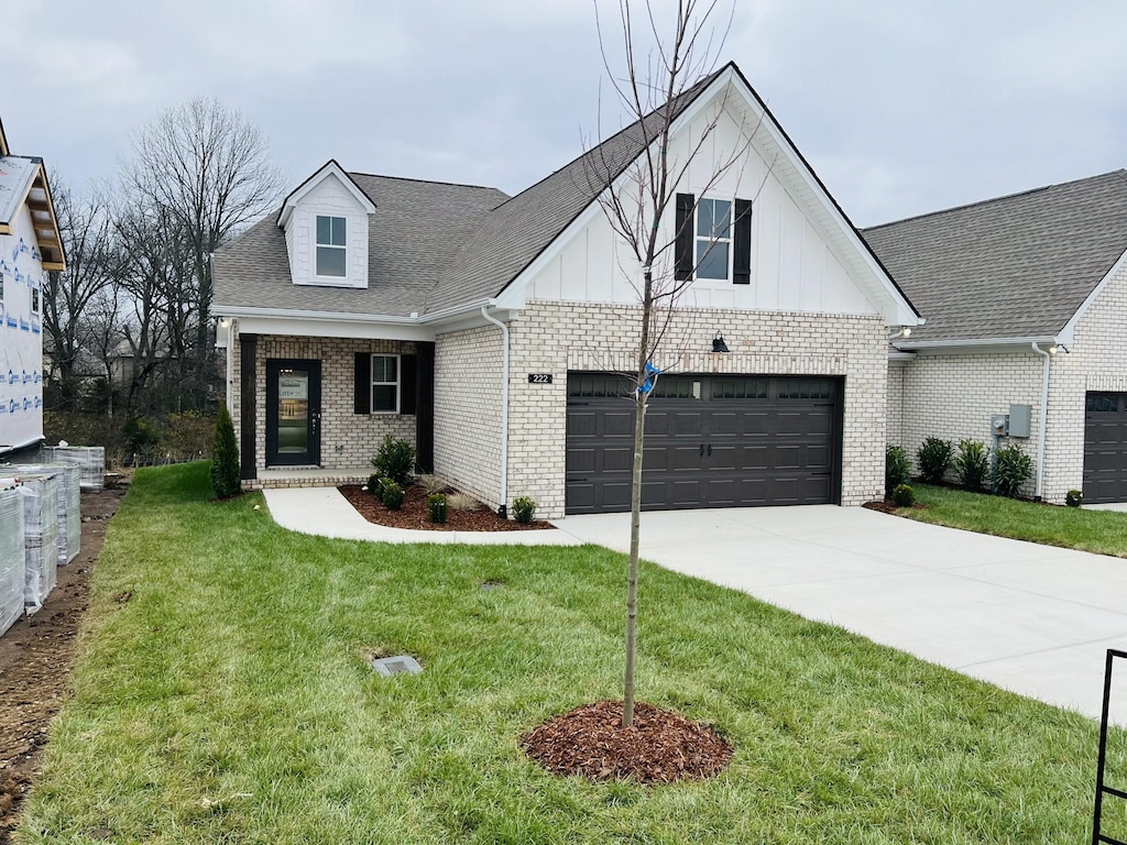 view of front facade with a front yard and a garage