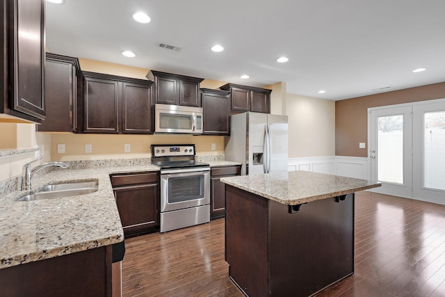 kitchen with a center island, stainless steel appliances, dark hardwood / wood-style floors, and sink