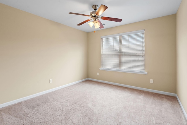 unfurnished room featuring light colored carpet and ceiling fan