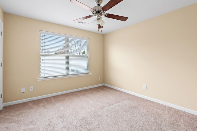 spare room featuring ceiling fan and carpet floors