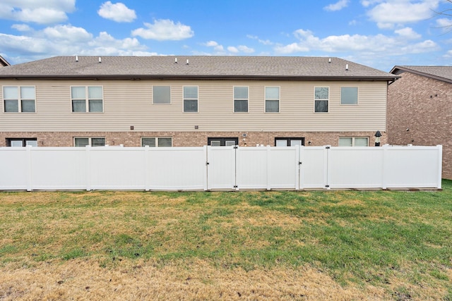 rear view of house with a lawn