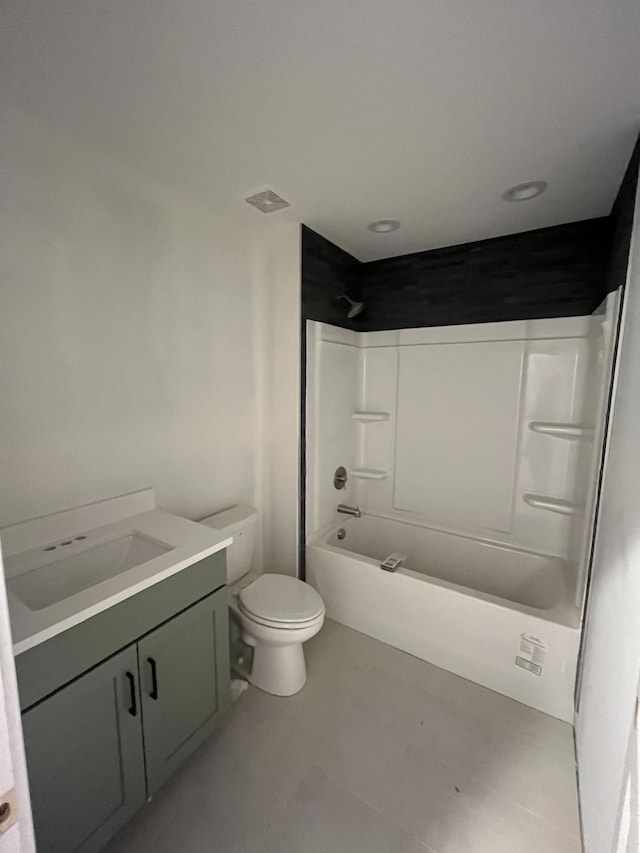 full bath featuring toilet, tile patterned flooring, shower / washtub combination, and vanity