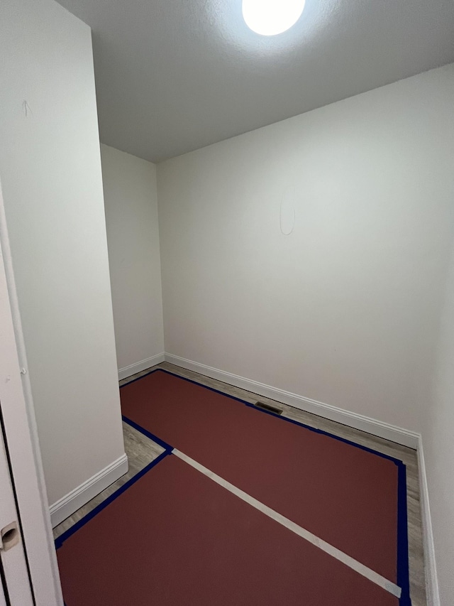 unfurnished room featuring baseboards