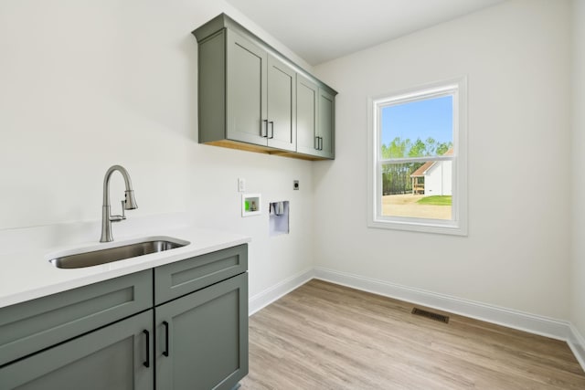 1049 Gholson Rd, Clarksville, TN 37043 - washroom with hookup for a washing machine, a sink, electric dryer hookup, cabinet space, and baseboards