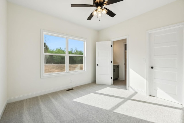 1049 Gholson Rd, Clarksville, TN 37043 - unfurnished bedroom with light carpet, baseboards, visible vents, and ceiling fan
