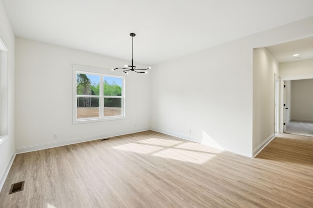 1049 Gholson Rd, Clarksville, TN 37043 - unfurnished room with light wood-type flooring, baseboards, an inviting chandelier, and visible vents