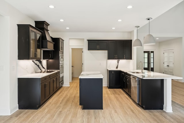 1049 Gholson Rd, Clarksville, TN 37043 - kitchen with dishwasher, a sink, light wood-style floors, and a kitchen island