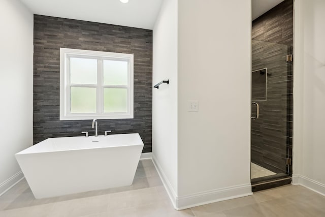 1049 Gholson Rd, Clarksville, TN 37043 - bathroom with a shower stall, a soaking tub, baseboards, and tile patterned flooring