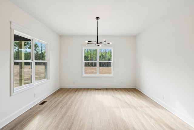 1049 Gholson Rd, Clarksville, TN 37043 - unfurnished dining area with visible vents, wood finished floors, a chandelier, and a healthy amount of sunlight
