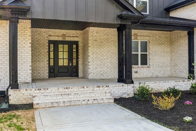 1049 Gholson Rd, Clarksville, TN 37043 - view of exterior entry featuring brick siding, board and batten siding, and covered porch