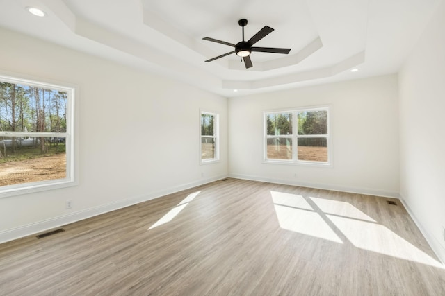 1049 Gholson Rd, Clarksville, TN 37043 - unfurnished room featuring a tray ceiling, wood finished floors, visible vents, baseboards, and ceiling fan