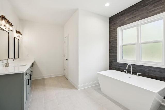 1049 Gholson Rd, Clarksville, TN 37043 - bathroom with a freestanding bath, vanity, baseboards, and recessed lighting