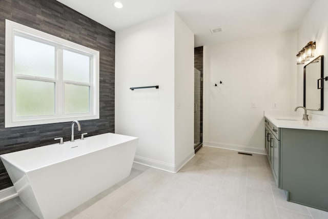 1049 Gholson Rd, Clarksville, TN 37043 - full bathroom featuring a freestanding tub, baseboards, vanity, and a stall shower