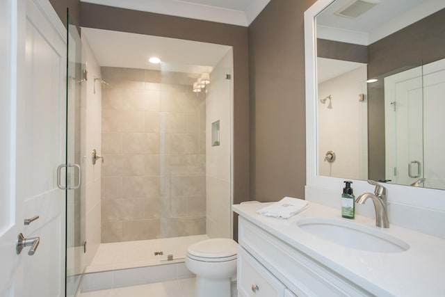 bathroom featuring toilet, a stall shower, visible vents, and vanity