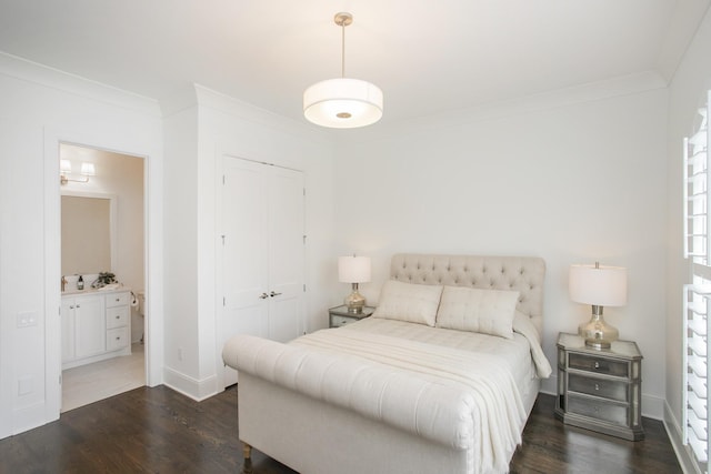 bedroom featuring baseboards, dark wood-type flooring, a closet, and crown molding