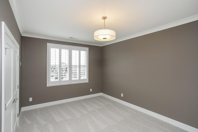 unfurnished room with light colored carpet, crown molding, visible vents, and baseboards