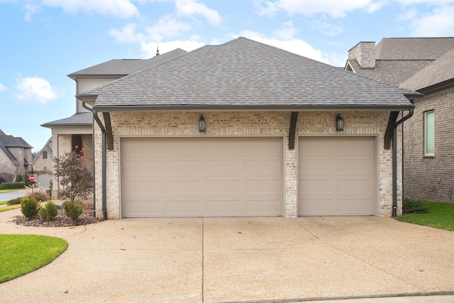 view of front of home featuring concrete driveway, a shingled roof, an attached garage, and brick siding