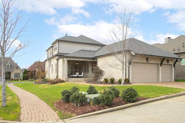 view of front of house featuring a garage, driveway, roof with shingles, stucco siding, and a front lawn