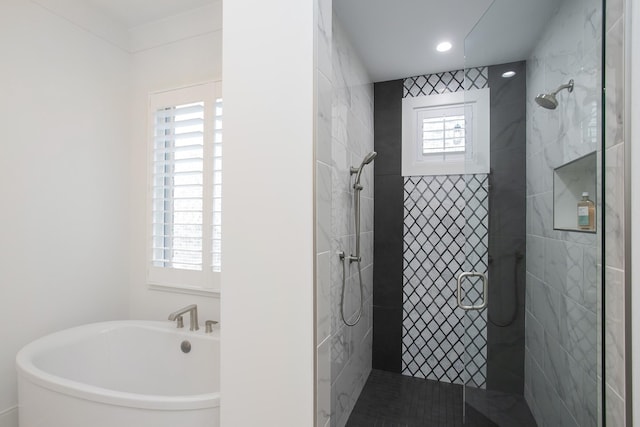 full bathroom featuring a freestanding bath, tiled shower, and recessed lighting