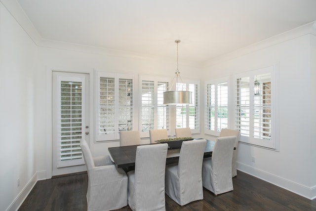 dining room with ornamental molding, dark wood finished floors, and baseboards