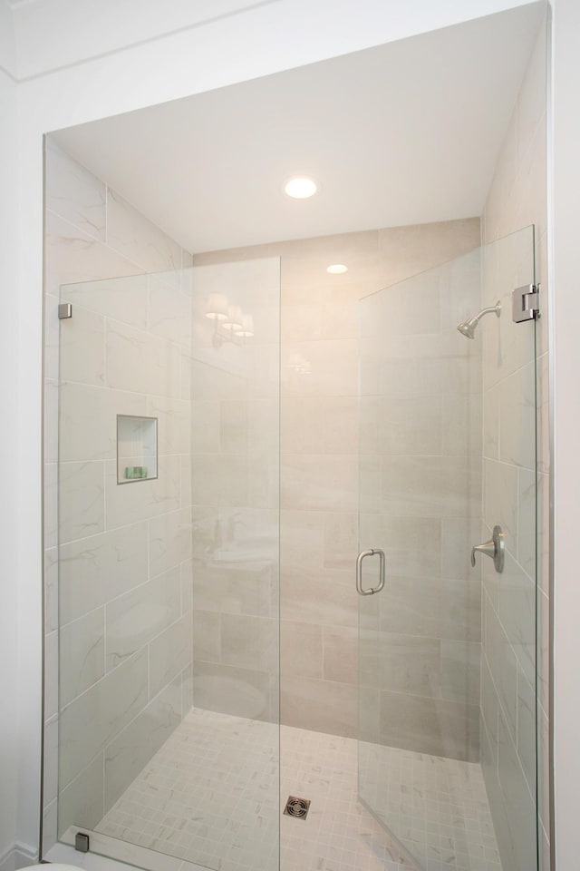 bathroom with recessed lighting and a shower stall