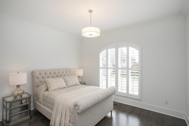 bedroom featuring baseboards, dark wood finished floors, and ornamental molding