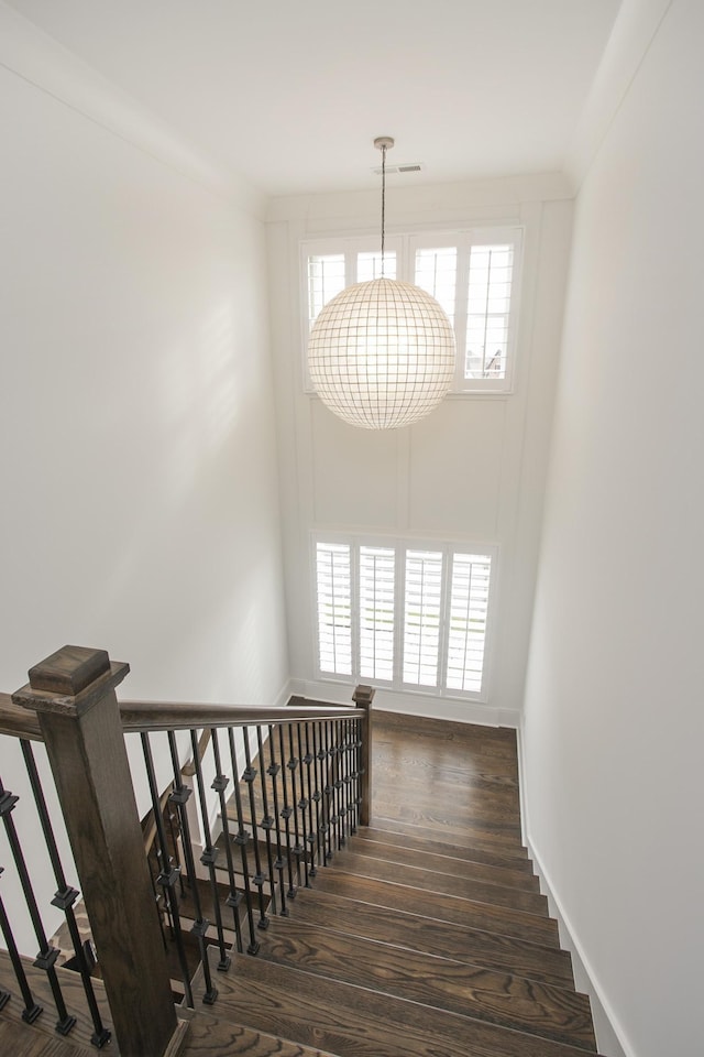 stairway featuring baseboards and wood finished floors