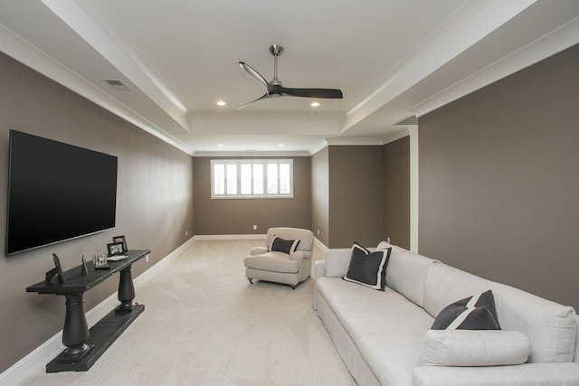 carpeted living room with a tray ceiling, recessed lighting, visible vents, and baseboards